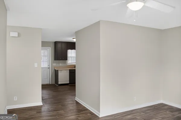 a kitchen with a refrigerator and a stove top oven