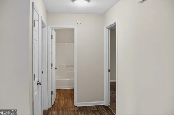a view of hallway with wooden floor