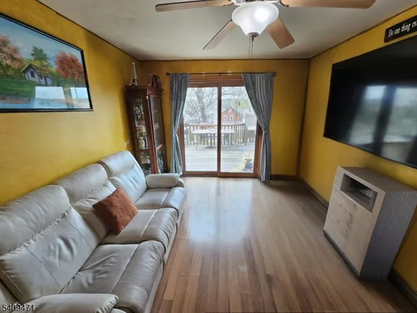 a spacious bedroom with a bed a couch and a flat screen tv