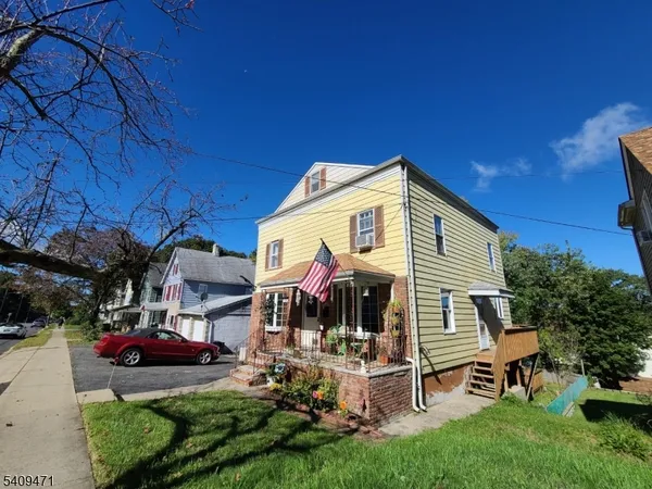 a view of a house with backyard porch and sitting area