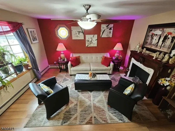 a living room with furniture chandelier and large window