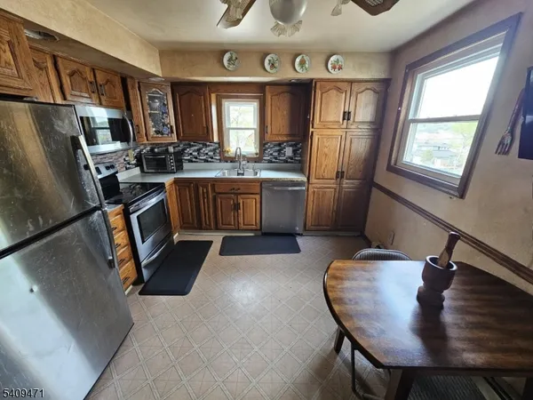 a kitchen with a refrigerator a stove and a sink