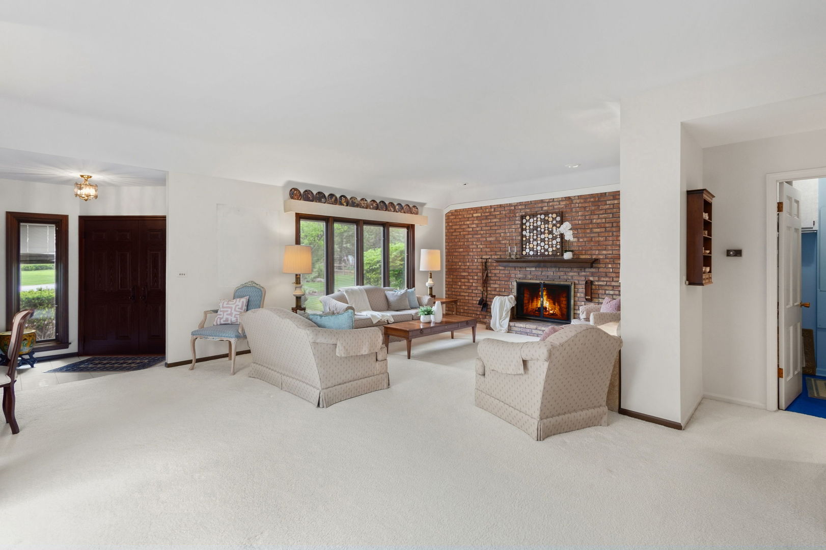715 Tomlin Drive, Unit A1 Burr Ridge, IL 60527 - Photo 5 of 24 a living room with furniture and a fireplace