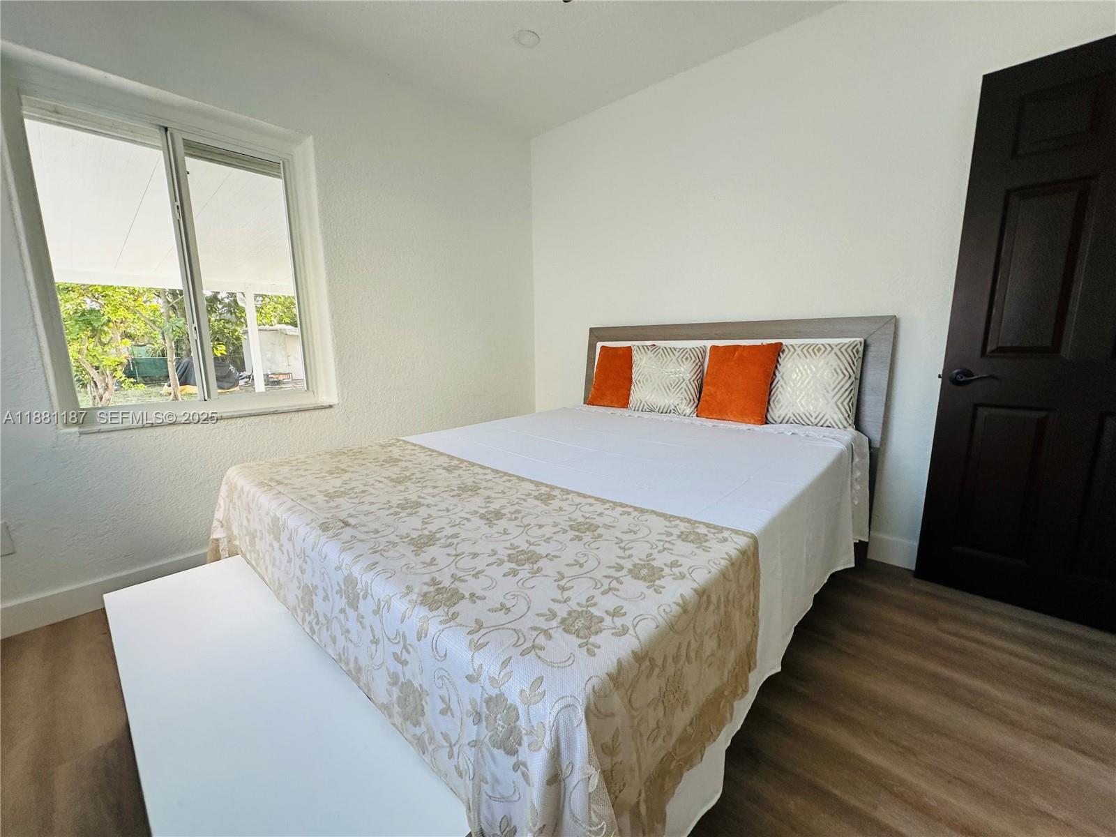 3052 Southwest 6th Street Miami, FL 33135 - Photo 12 of 15 a room with a bed and a large window