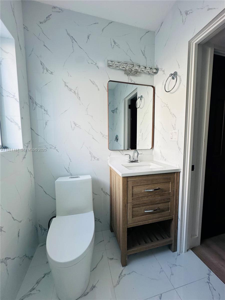 3052 Southwest 6th Street Miami, FL 33135 - Photo 14 of 15 a bathroom with a toilet sink and mirror