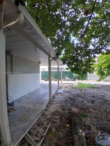 a view of a backyard with large trees