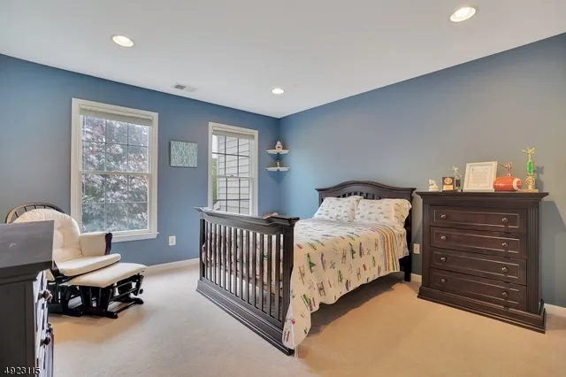 a spacious bedroom with a bed and a window