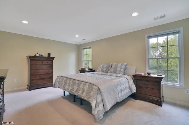 a spacious bedroom with a bed and a window