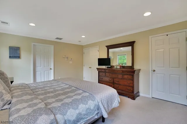 a bedroom with a bed and a television