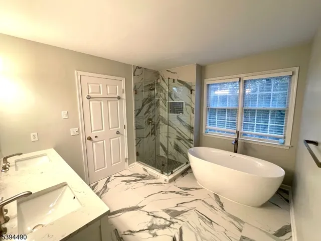 a spacious bedroom with a bed and glass door