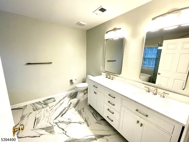 a bathroom with a double vanity sink and mirror