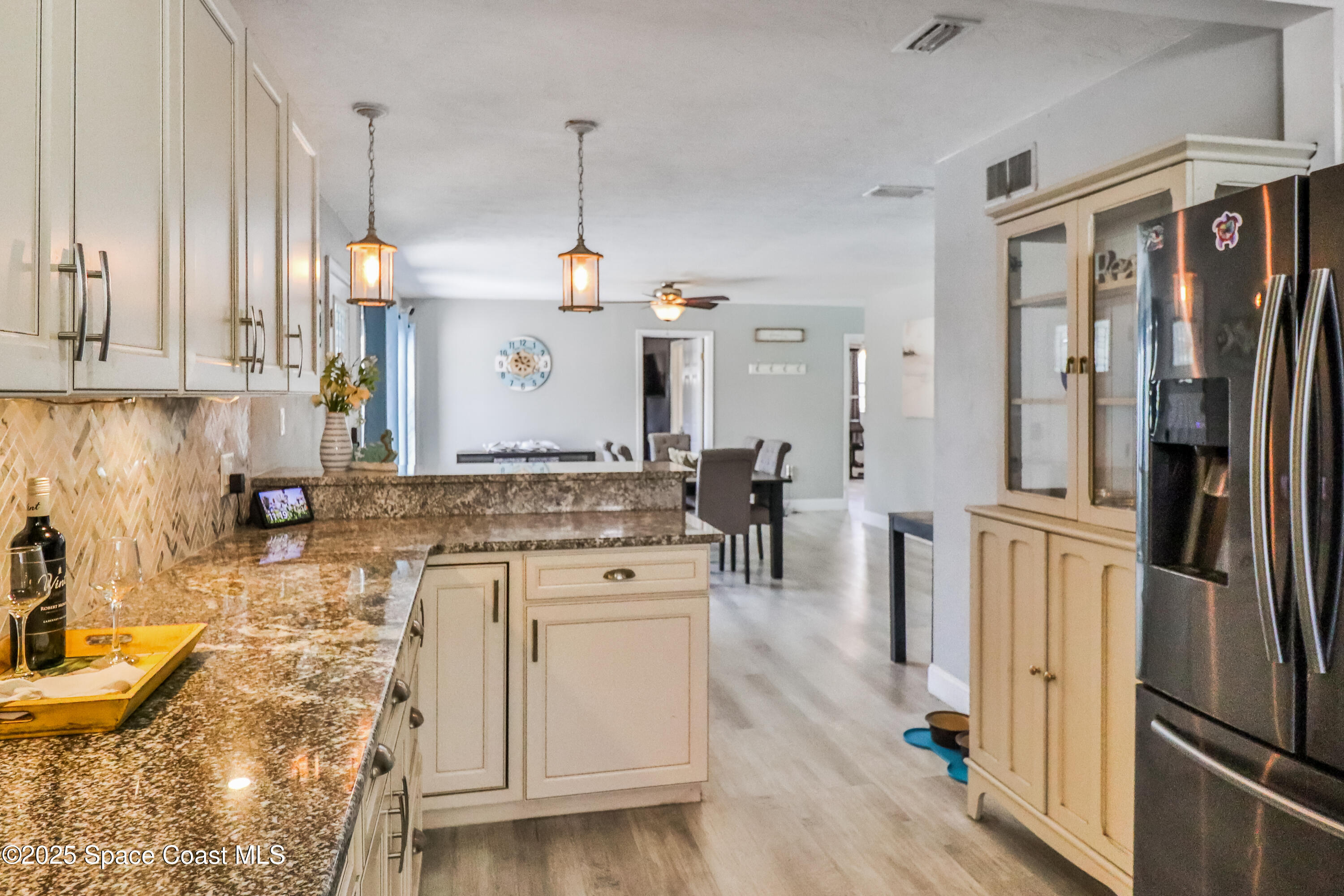 348 Berkeley Street Satellite Beach, FL 32937 - Photo 12 of 46 a kitchen with stainless steel appliances granite countertop a sink a stove and a refrigerator
