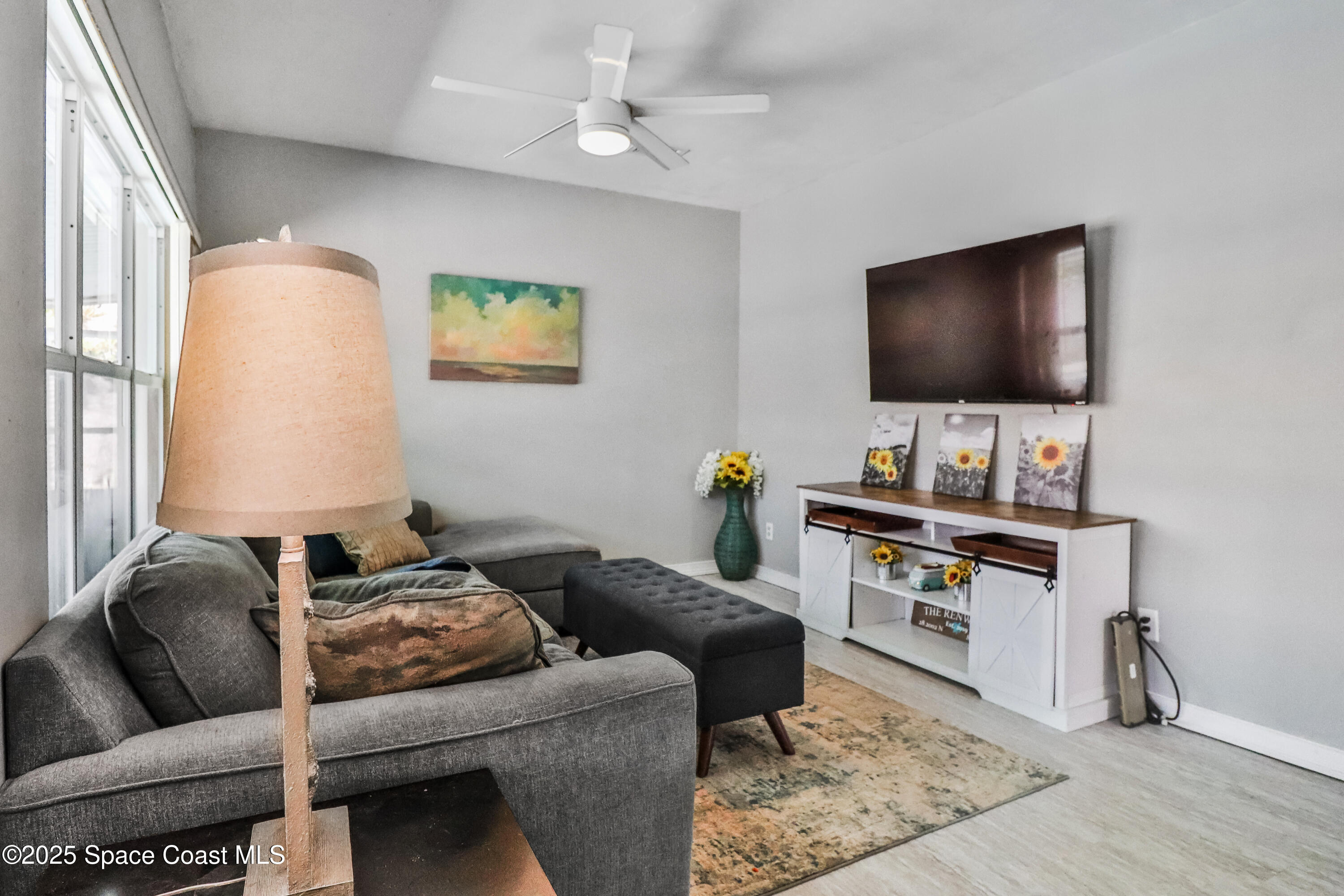 348 Berkeley Street Satellite Beach, FL 32937 - Photo 18 of 46 a living room with furniture and a flat screen tv