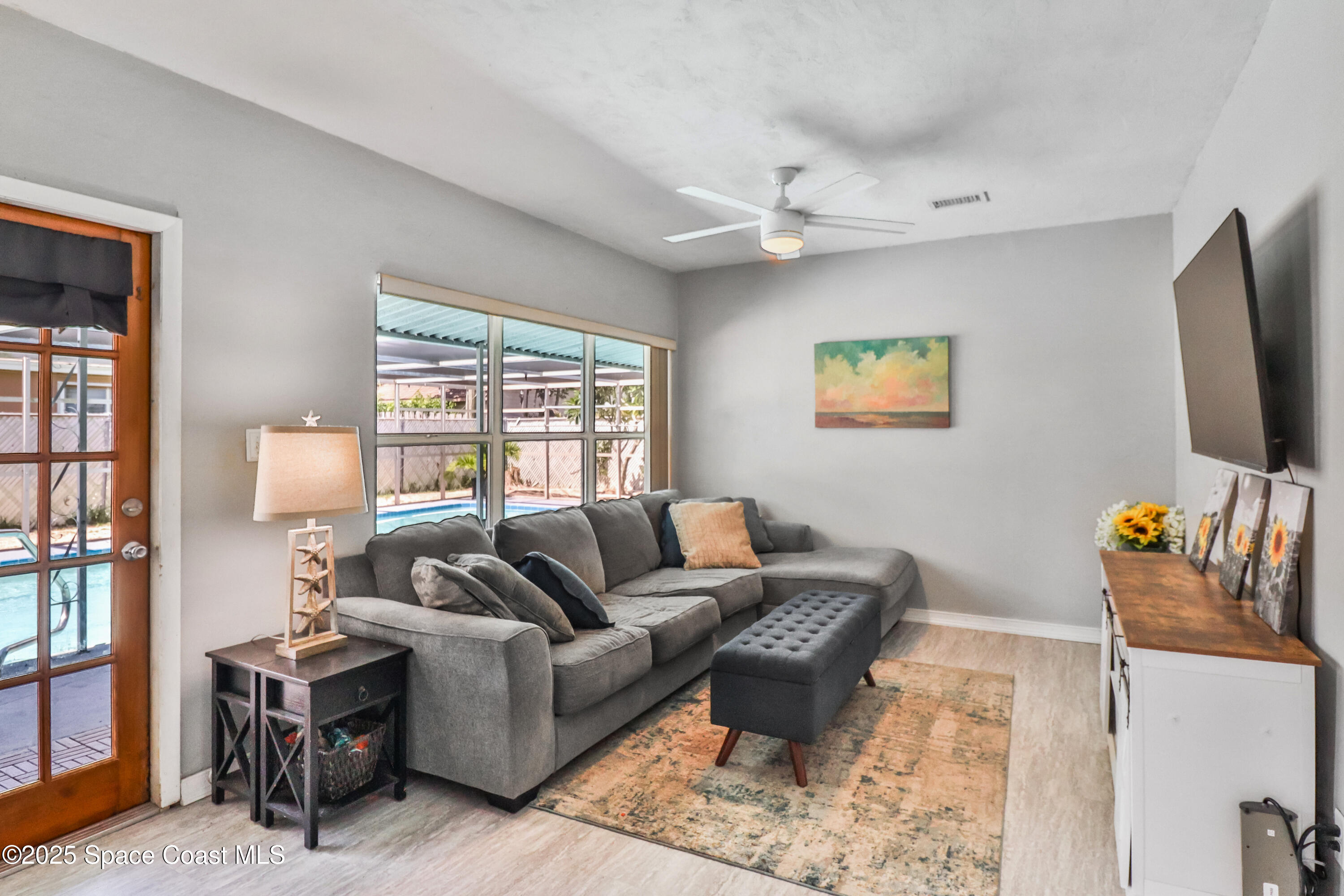 348 Berkeley Street Satellite Beach, FL 32937 - Photo 19 of 46 a living room with furniture and a flat screen tv