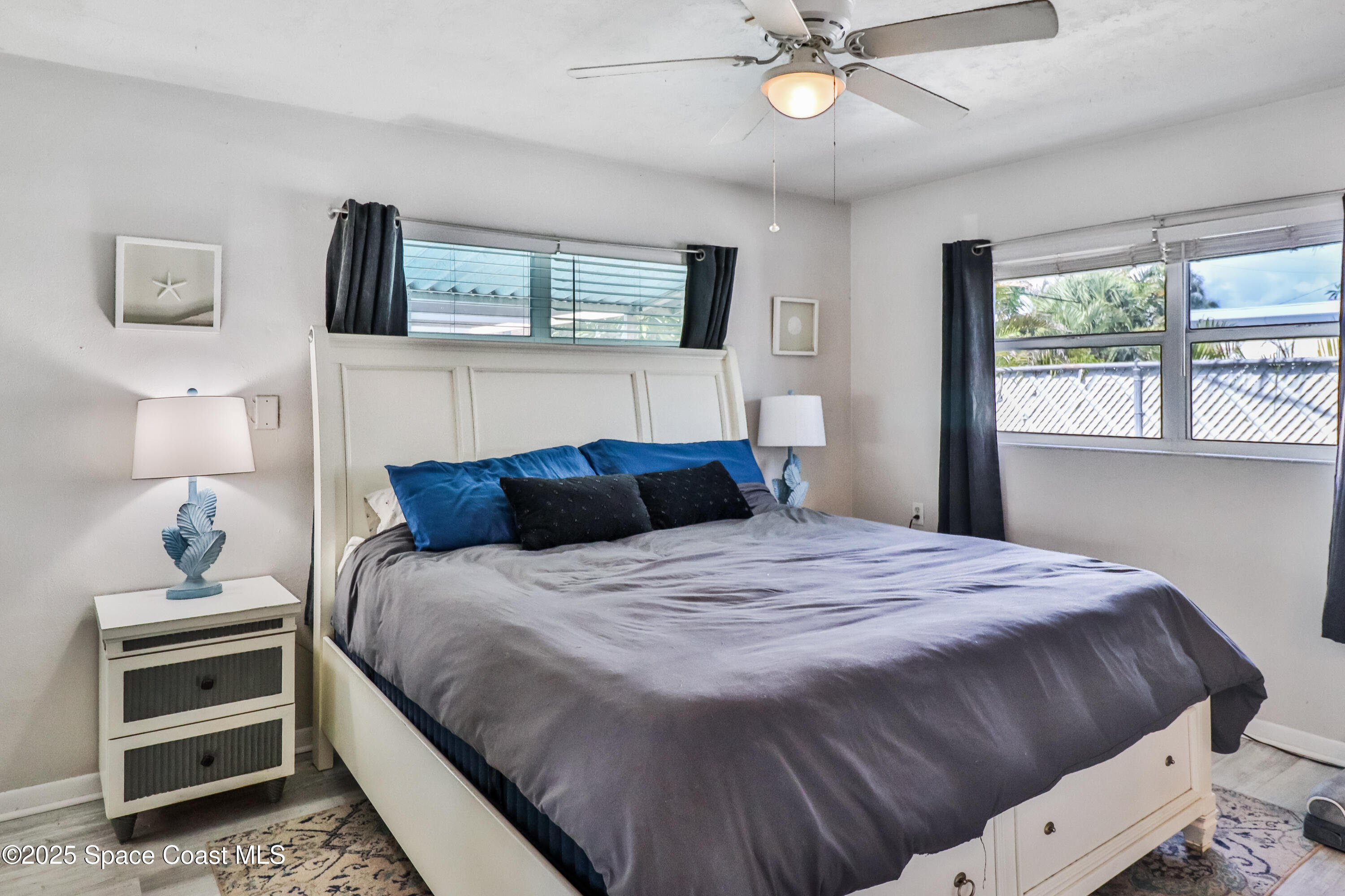 348 Berkeley Street Satellite Beach, FL 32937 - Photo 20 of 46 a bedroom with a bed and a window