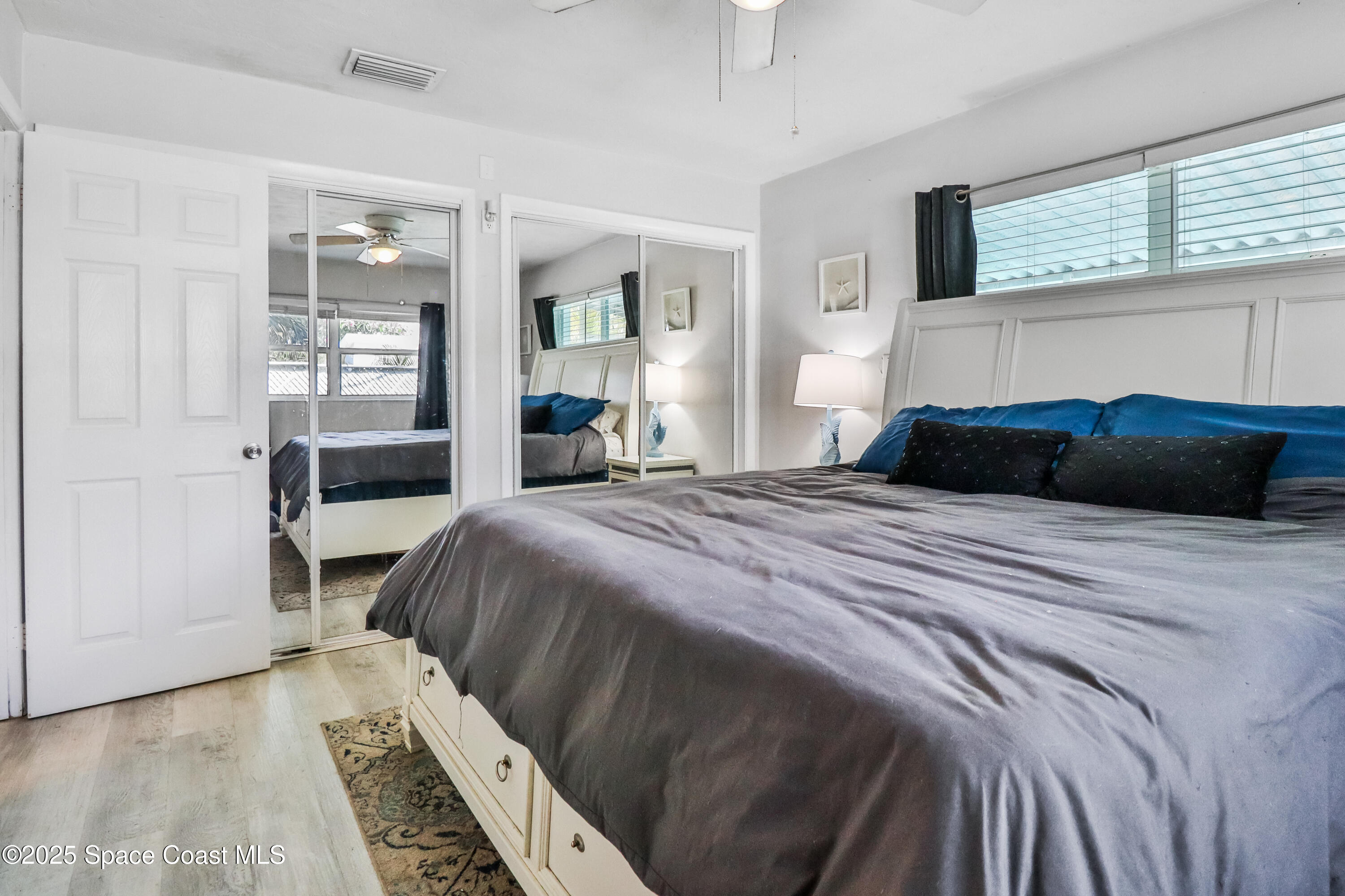 348 Berkeley Street Satellite Beach, FL 32937 - Photo 21 of 46 a bedroom with a bed and a window