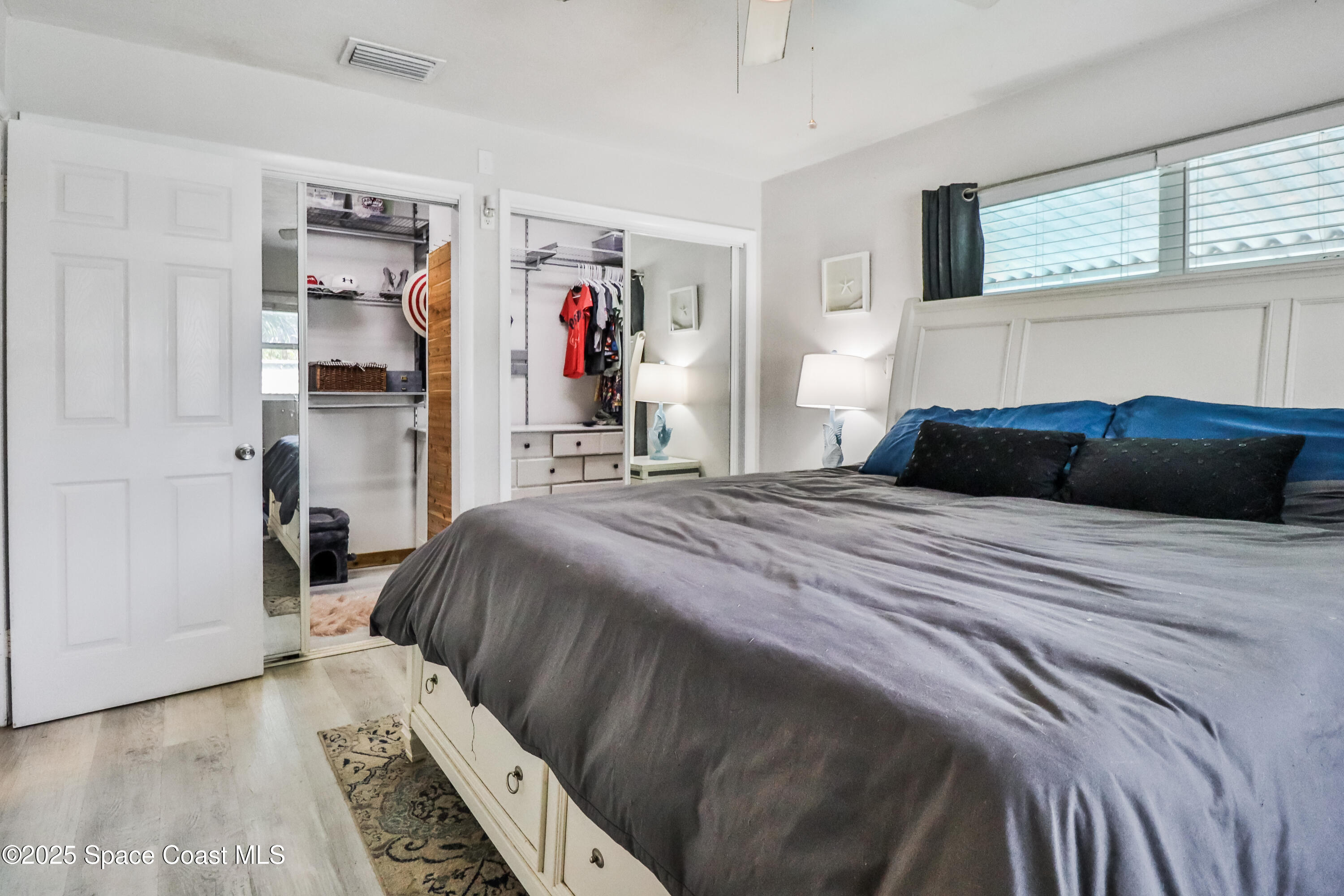 348 Berkeley Street Satellite Beach, FL 32937 - Photo 22 of 46 a bedroom with a bed and a window