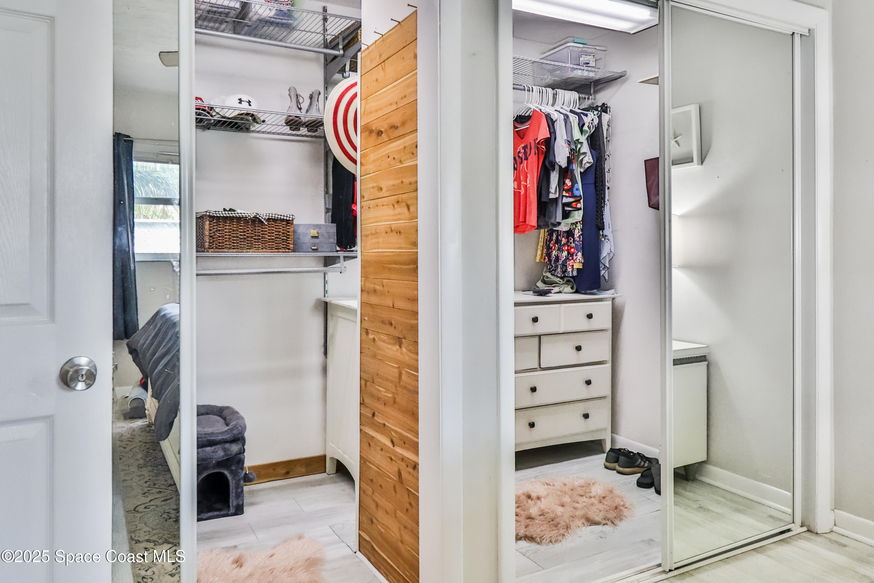 348 Berkeley Street Satellite Beach, FL 32937 - Photo 23 of 46 a view of walk in closet with clothes and shoes