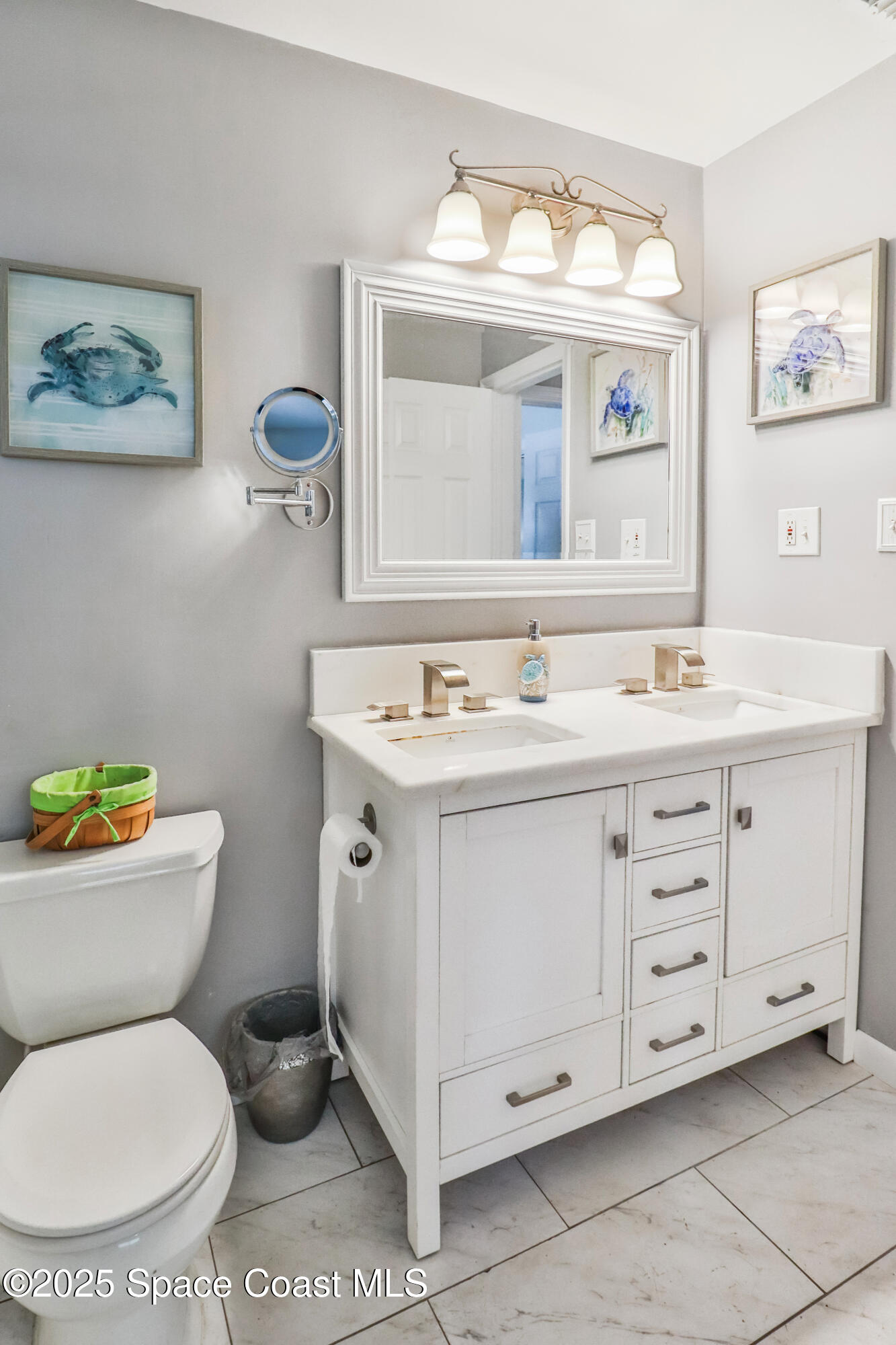 348 Berkeley Street Satellite Beach, FL 32937 - Photo 25 of 46 a bathroom with a toilet sink and mirror