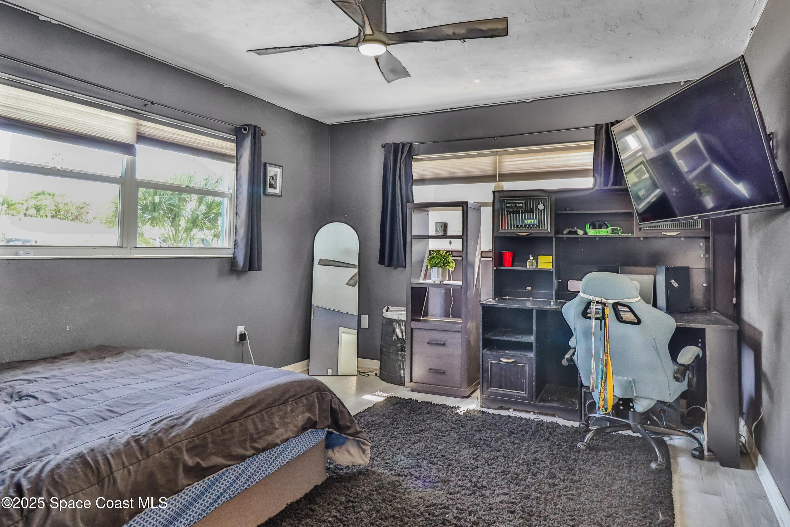 348 Berkeley Street Satellite Beach, FL 32937 - Photo 26 of 46 a bedroom with a bed and a window