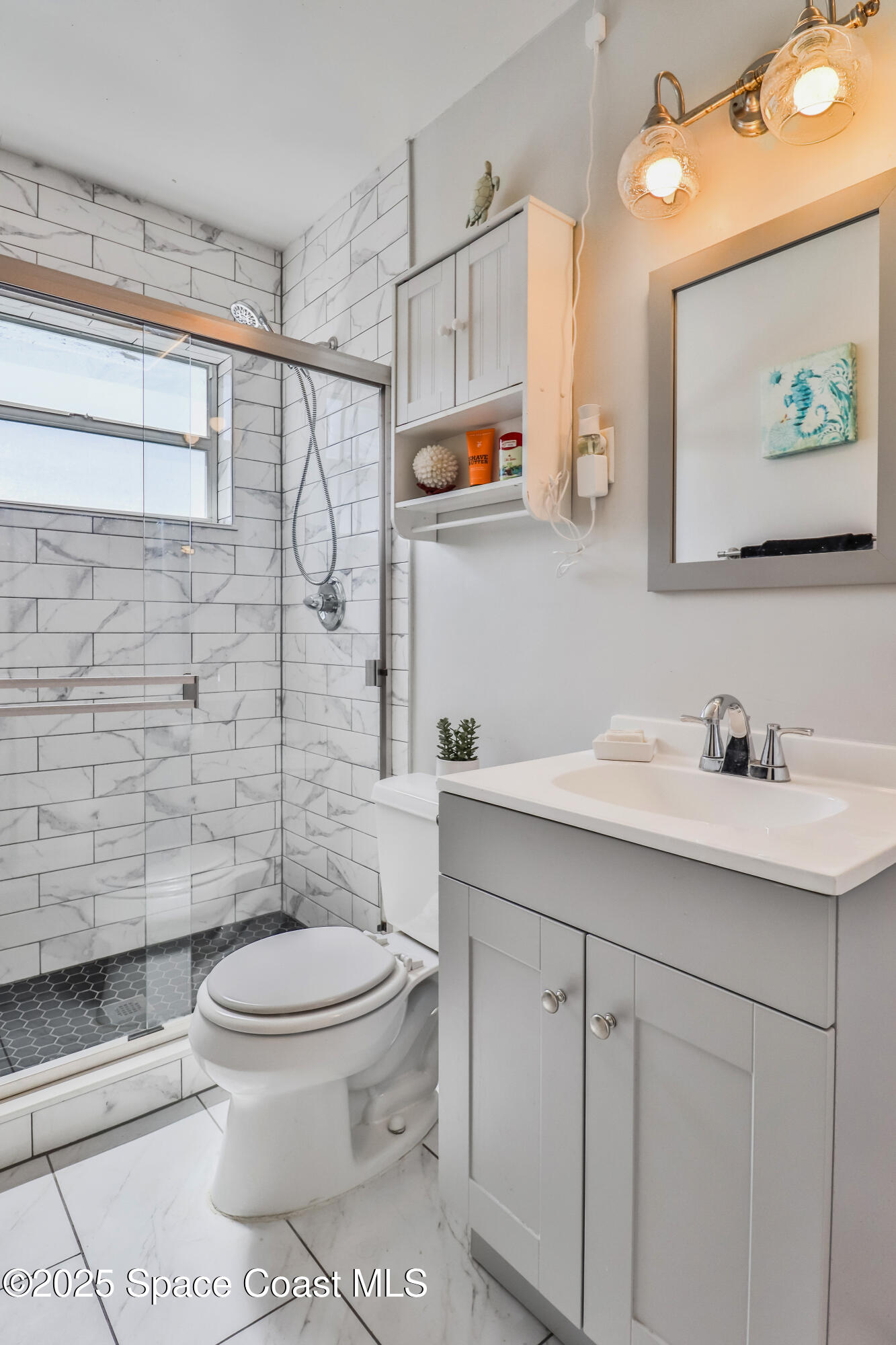 348 Berkeley Street Satellite Beach, FL 32937 - Photo 28 of 46 a bathroom with a toilet sink and mirror
