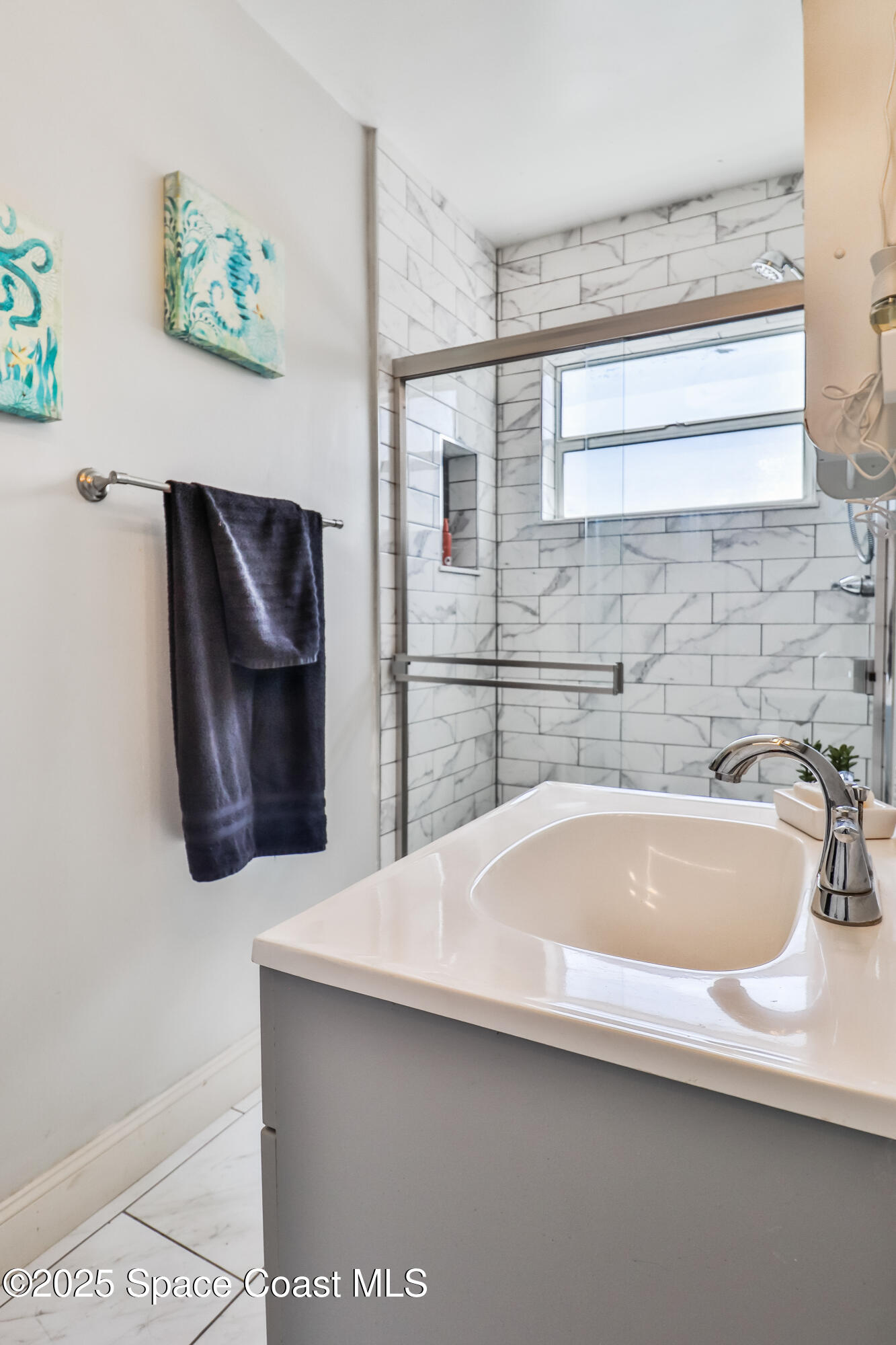 348 Berkeley Street Satellite Beach, FL 32937 - Photo 29 of 46 a bathroom with a sink and a bathtub