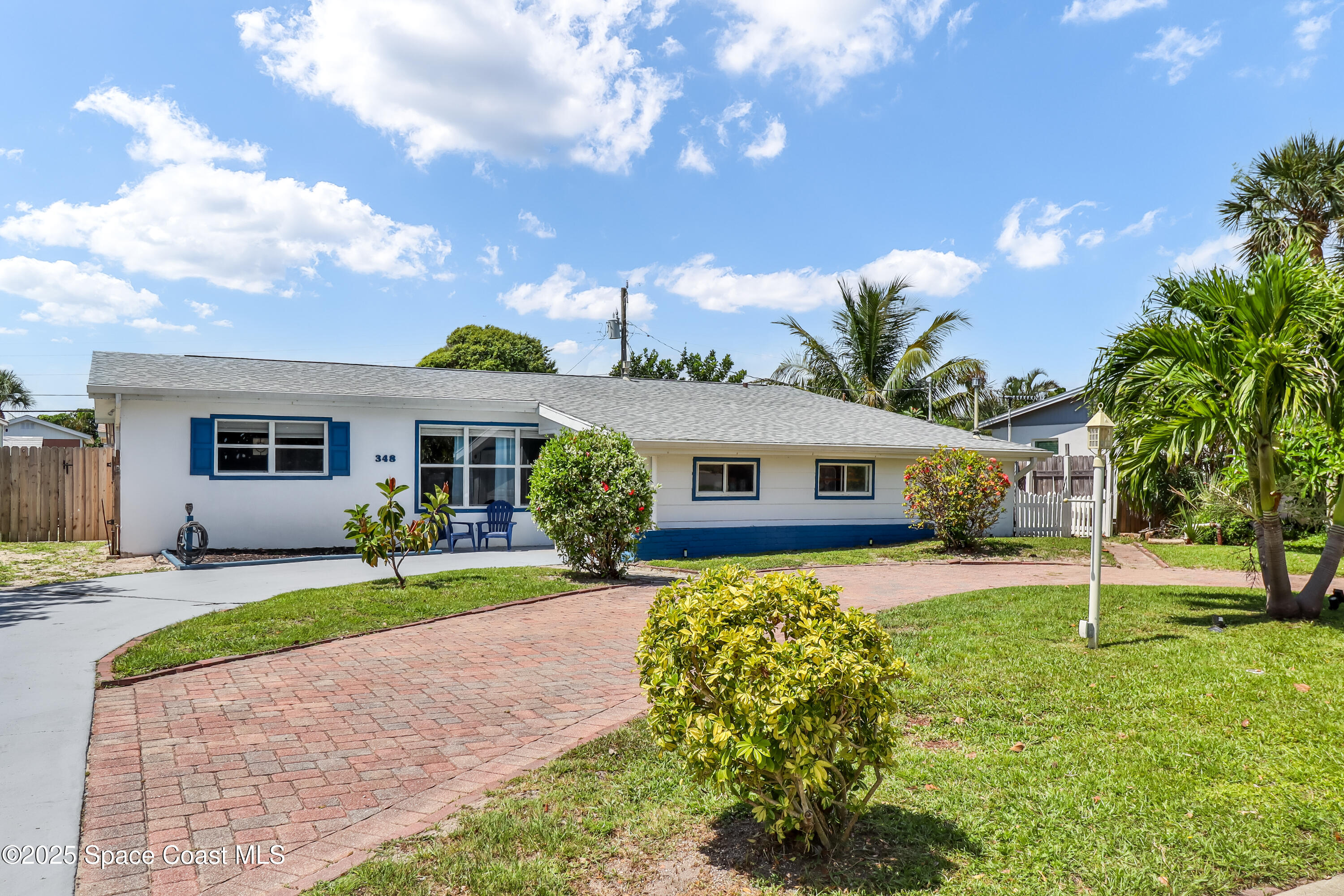 348 Berkeley Street Satellite Beach, FL 32937 - Photo 41 of 46 a front view of house with yard and trees