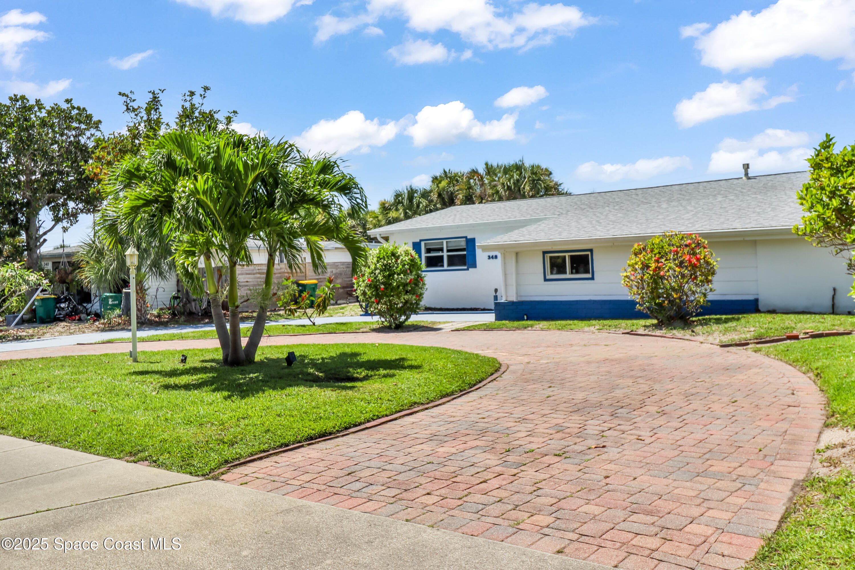 348 Berkeley Street Satellite Beach, FL 32937 - Photo 42 of 46 a front view of a house with a garden and yard