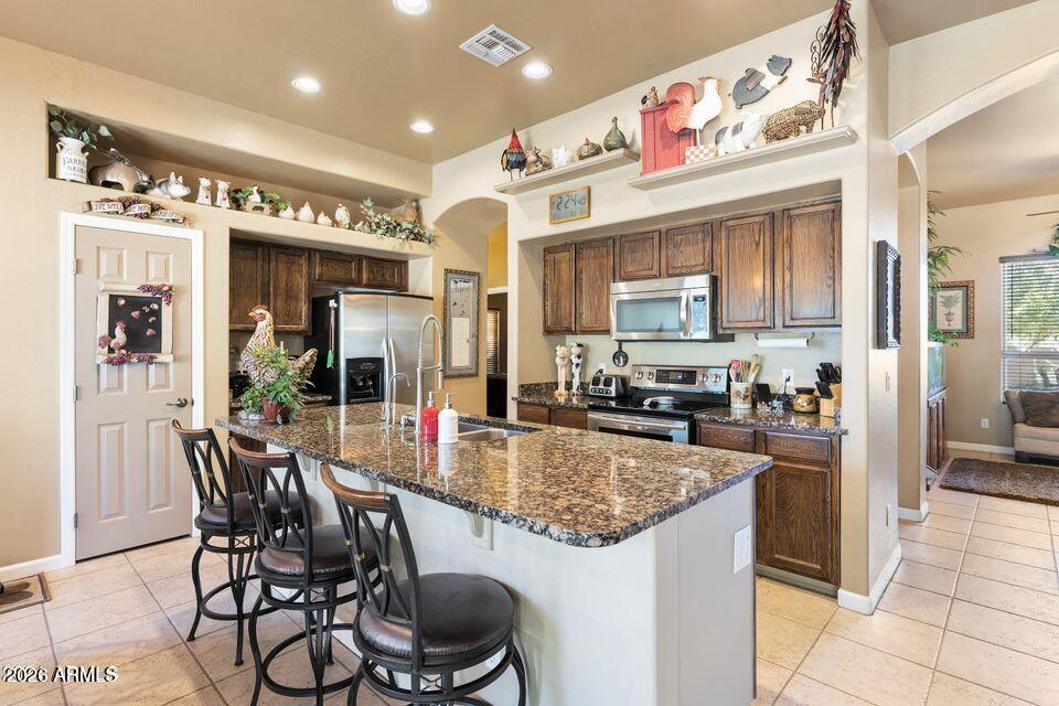37005 North 7th Street Phoenix, AZ 85086 - Photo 18 of 48 a kitchen with stainless steel appliances granite countertop a stove and a refrigerator