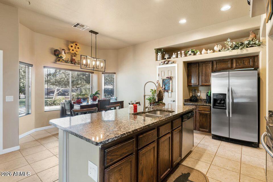 37005 North 7th Street Phoenix, AZ 85086 - Photo 19 of 48 a kitchen with granite countertop stainless steel appliances a sink counter space and a view of kitchen