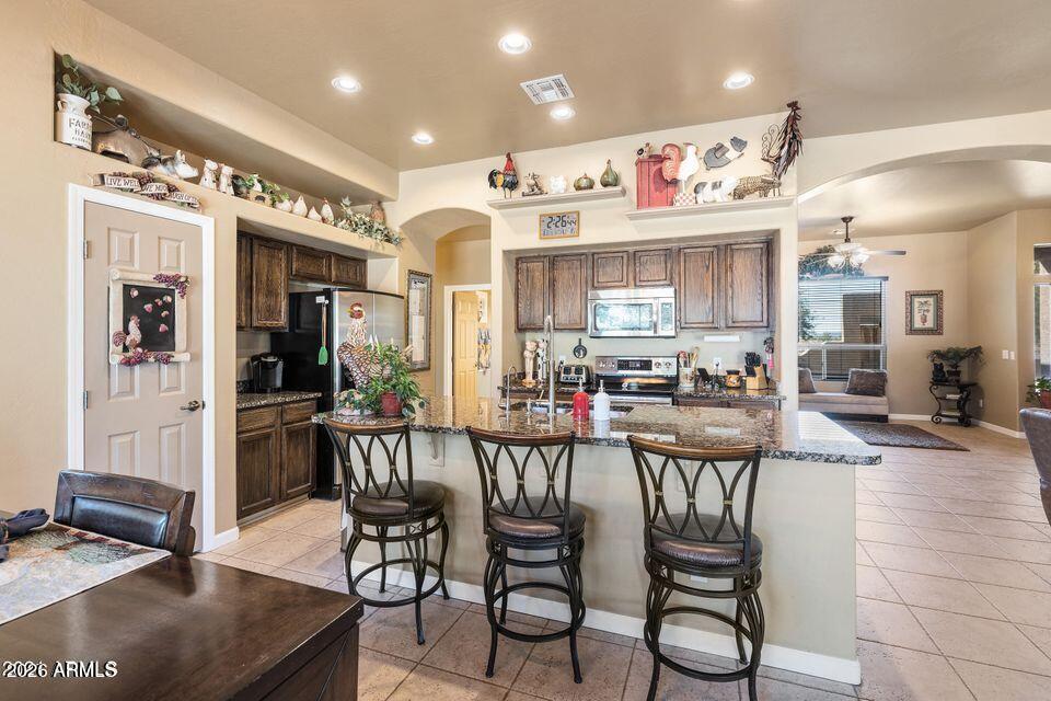 37005 North 7th Street Phoenix, AZ 85086 - Photo 21 of 48 a view of a dining room with furniture and chandelier