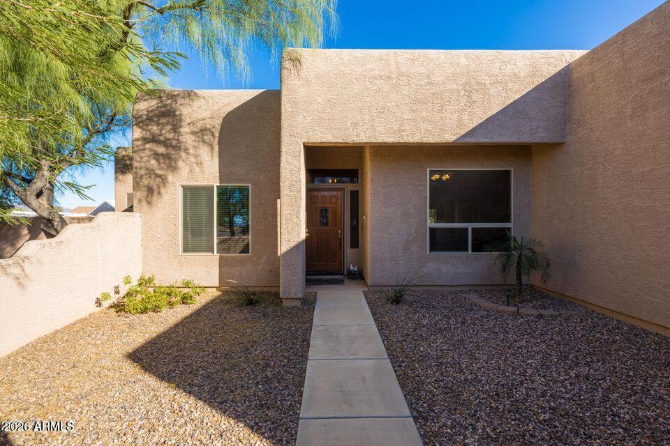 37005 North 7th Street Phoenix, AZ 85086 - Photo 34 of 48 a view of a house with a small yard and potted plants