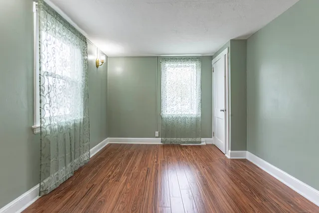 a view of wooden floor and windows in a room