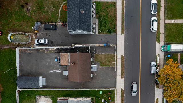an aerial view of a residential houses with outdoor space