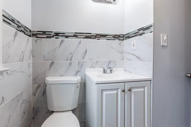 a bathroom with a sink a toilet and a mirror