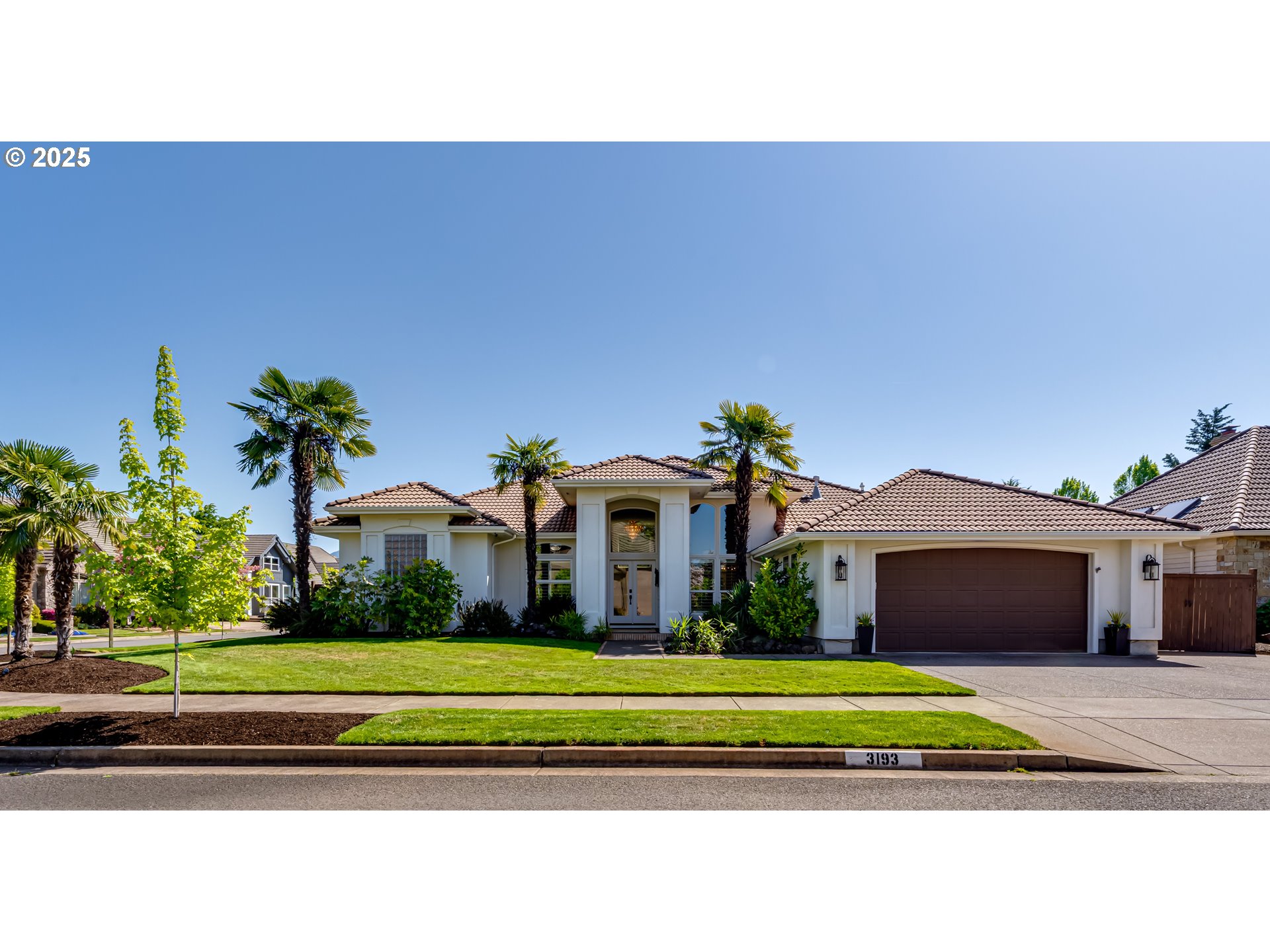 a front view of a house with a yard and a garage
