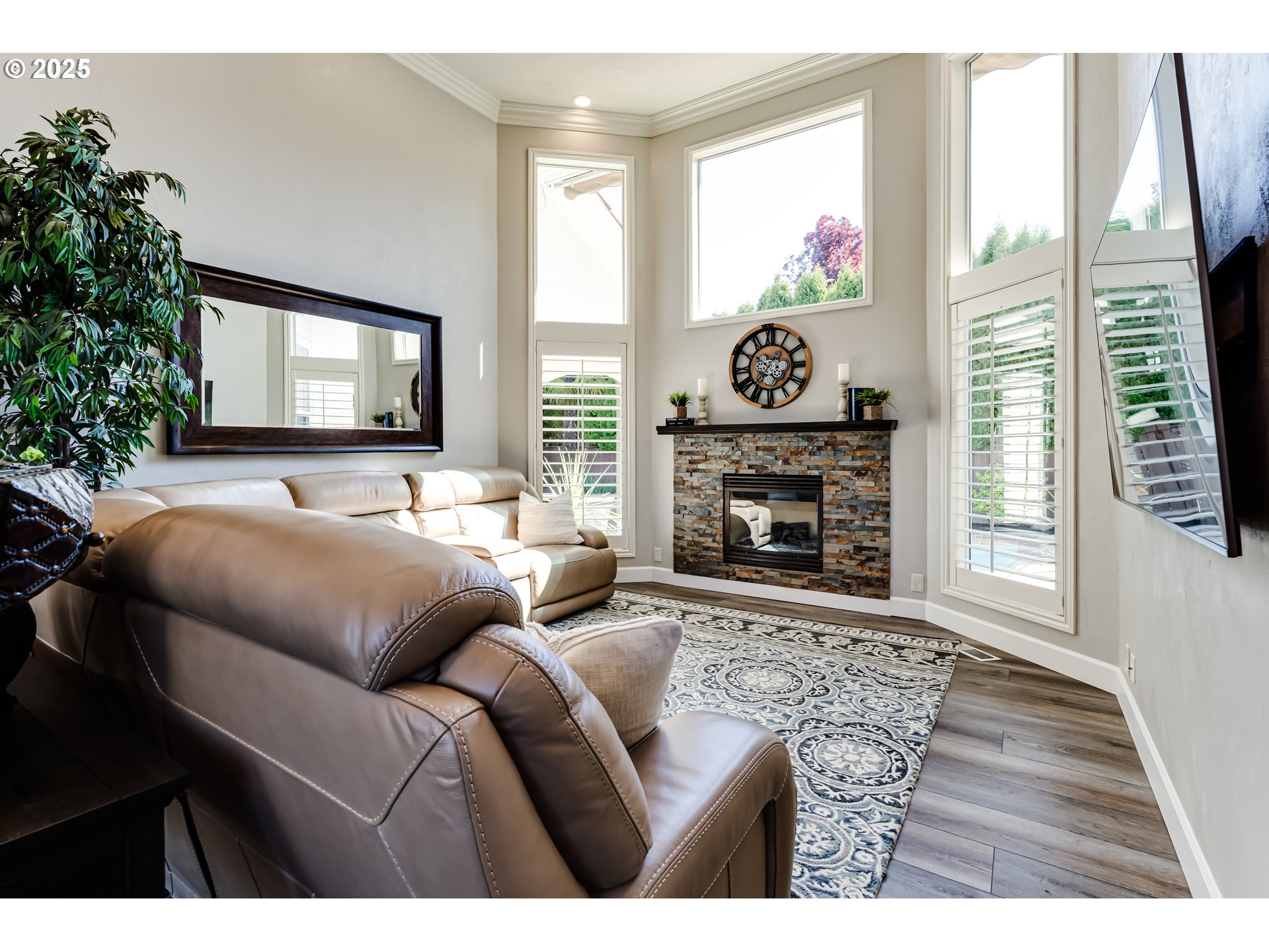 3193 Metolius Drive Eugene, OR 97408 - Photo 8 of 39 a living room with furniture a fireplace a flat screen tv and a large window