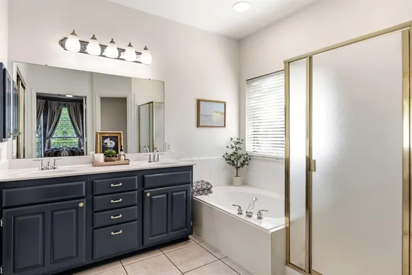 a view of swimming pool with lawn chairs under an umbrella