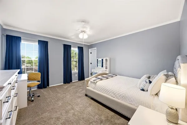 an aerial view of residential houses with outdoor space and trees