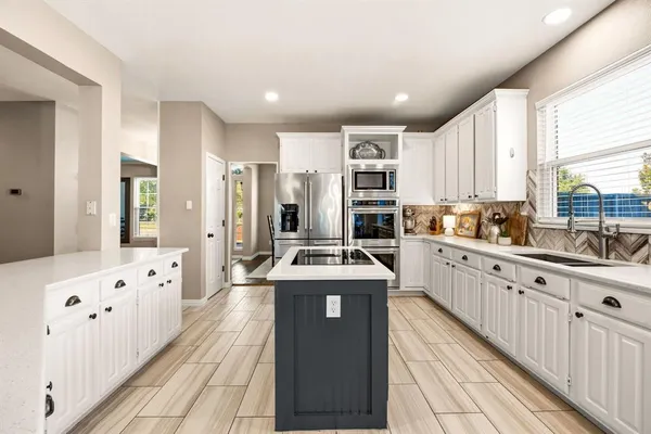 a spacious bedroom with a bed and a chandelier