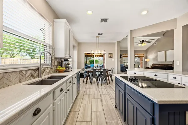 a bedroom with a bed chandelier and a large window