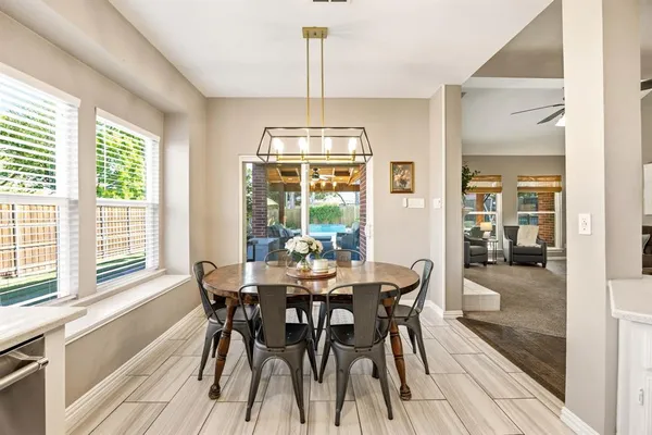 a bathroom with a tub a sink double vanity and a mirror