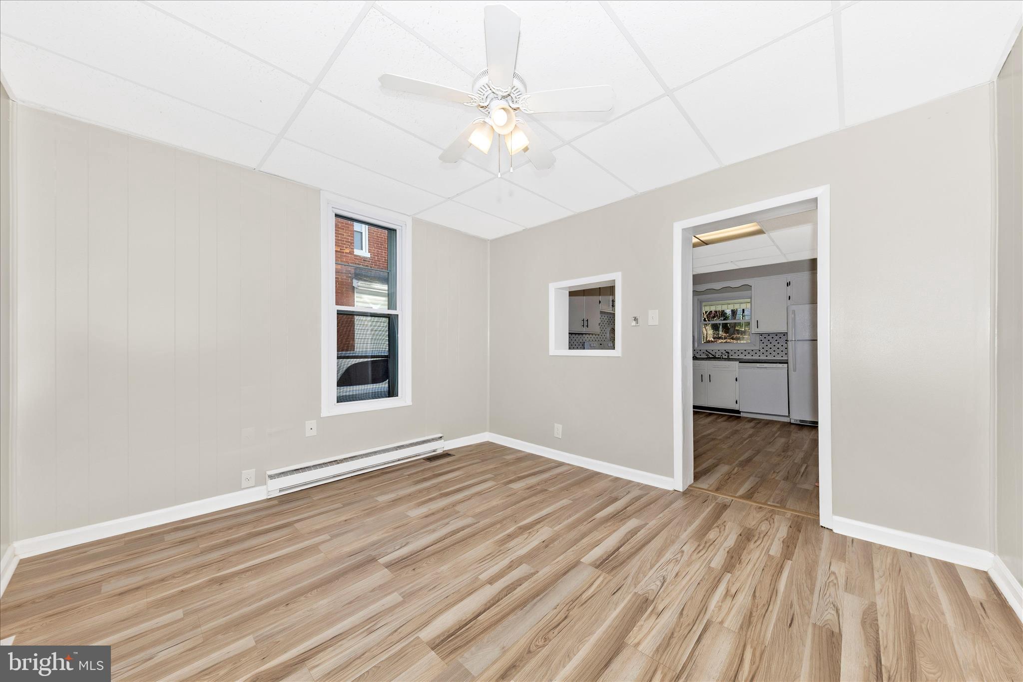 148 Hamilton Avenue Waynesboro, PA 17268 - Photo 11 of 50 an empty room with wooden floor chandelier fan and windows