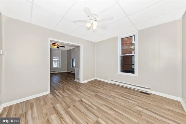 a view of an empty room with wooden floor