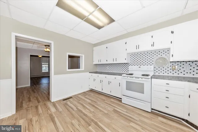 a kitchen with stainless steel appliances a white cabinets and sink