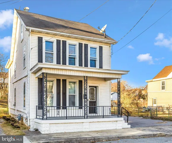 a view of a white house with large windows