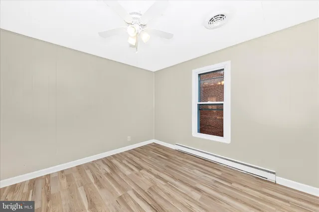 wooden floor in an empty room with a window