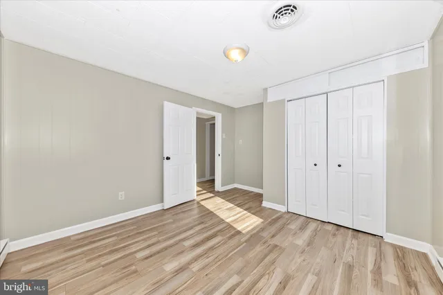 a bathroom with a white tub a sink and a large mirror