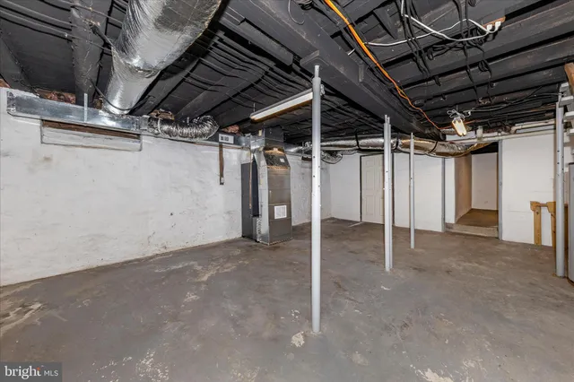 a view of a big house with a big yard and large trees