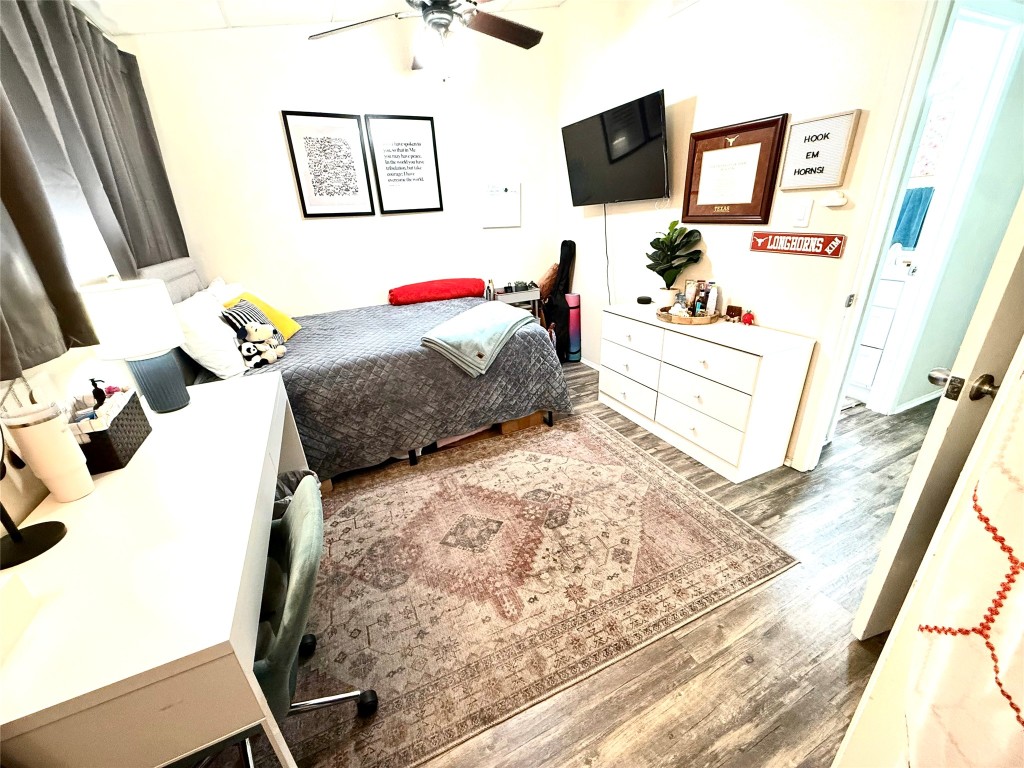 2413 Leon Street, Unit 108 Austin, TX 78705 - Photo 10 of 22 a bedroom with a bed a flat screen tv and a bed